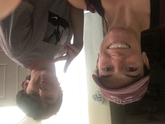 Domenic making a peace sign in a photo with his mom